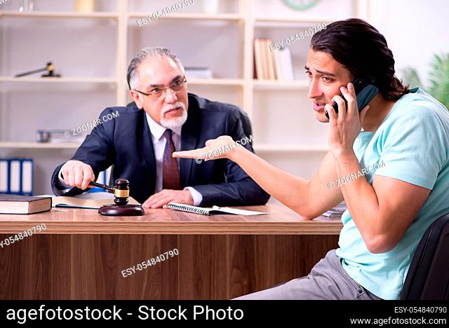 The young man visiting experienced male lawyer