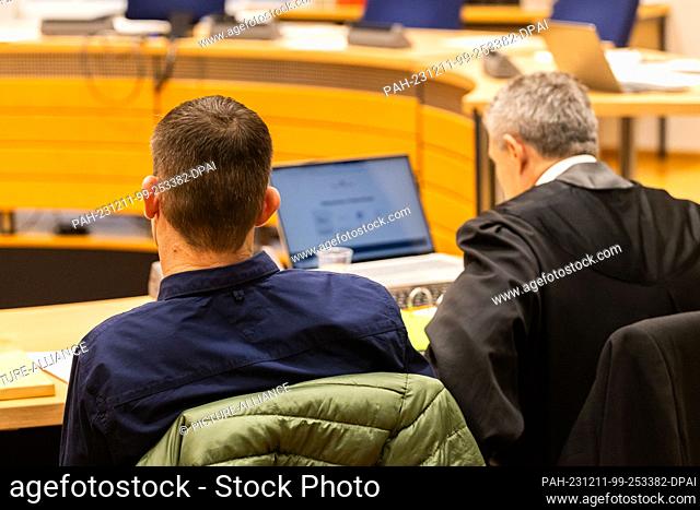 11 December 2023, Baden-Württemberg, Waldshut-Tiengen: A defendant (l) sits next to his defense lawyer (r). The accused (39), who comes from Latvia