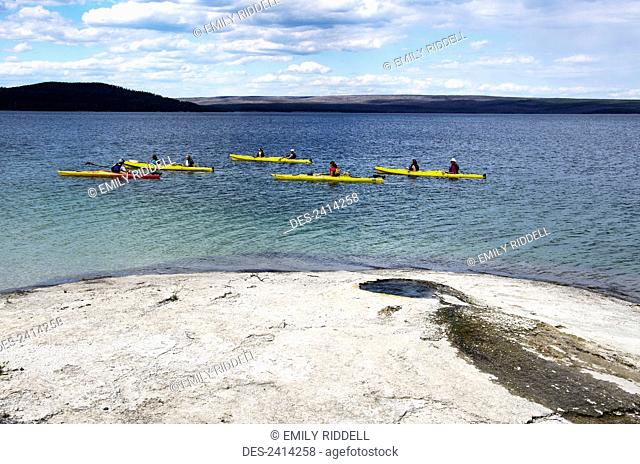 Five kayaks on West Thumb arm of Yellowstone Lake in front of Big Cone, Yellowstone National Park; Wyoming, United States of America