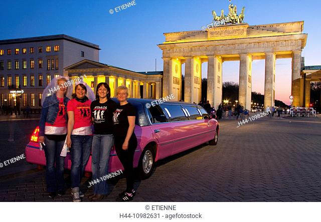 pink cadillac and women at Brandenburg Gate by night in Berlin