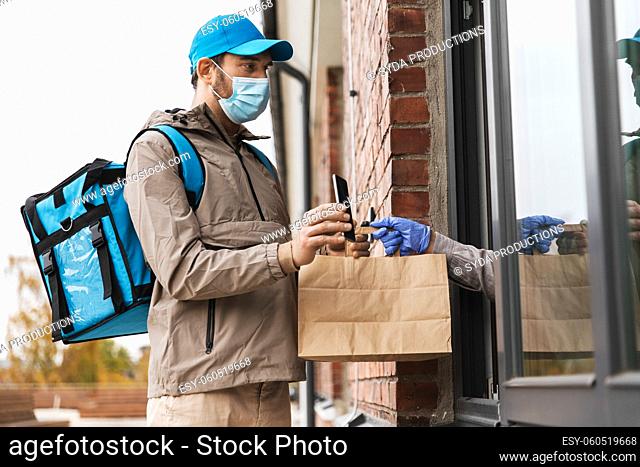food delivery man in mask giving order to customer