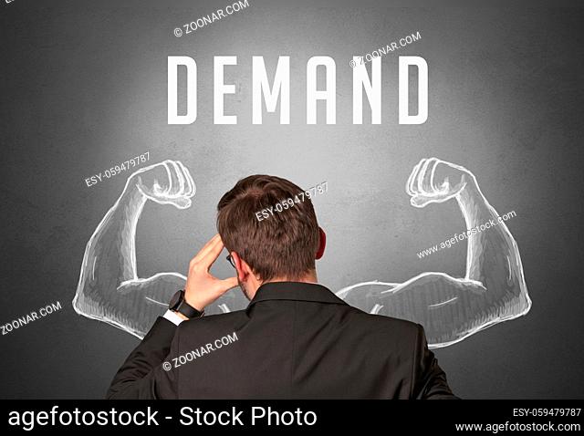 Rear view of a businessman with DEMAND inscription, powerfull business concept