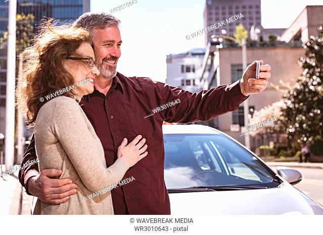 Senior couple taking a selfie on the road