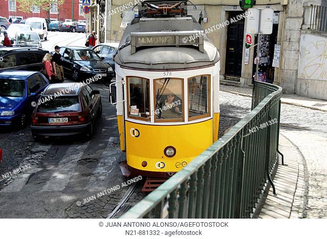 Rua de Sao Tome leading to the MIradouro de Santa Luzia. The tram is going down Travessa de Sao Tome. Alfama, Lisbon, Portugal