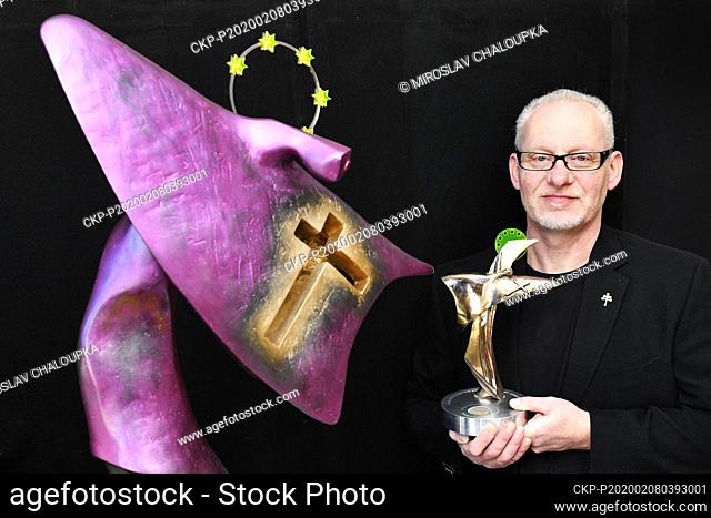 Czech sculptor Vaclav Cesak poses with one of three statuettes of St John of Nepomuk, right, on February 8, 2020, in Novy Smolivec, Czech Republic