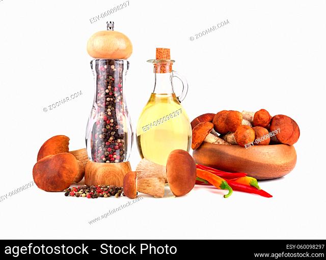 Pepper mill with Olive oil, king boletus mushrooms and chili pepper isolated on white background