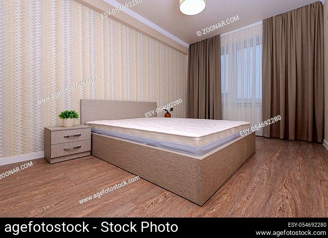 Brand new almost empty brown bedroom with bare mattress at twin bed, bedside tables and curtain