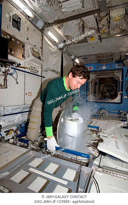 Astronaut Michael Barratt, Expedition 1920 flight engineer, performs an insertion of urine samples into the Minus Eighty Degree Laboratory Freezer for ISS...