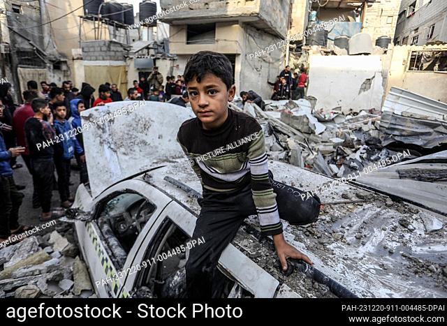 20 December 2023, Palestinian Territories, Rafah: A Palestinian boy inspects the damage caused by Israeli airstrikes on the Mansour family house