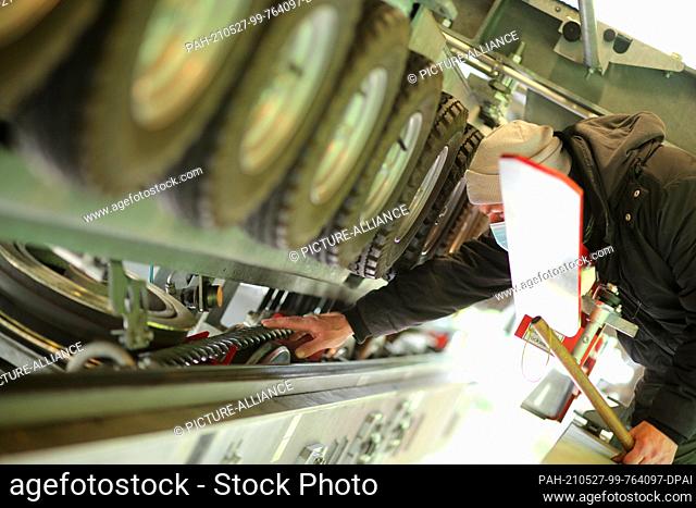 27 May 2021, Saxony-Anhalt, Thale: The technical equipment as well as the haul rope of the cable car are checked on a rain basis