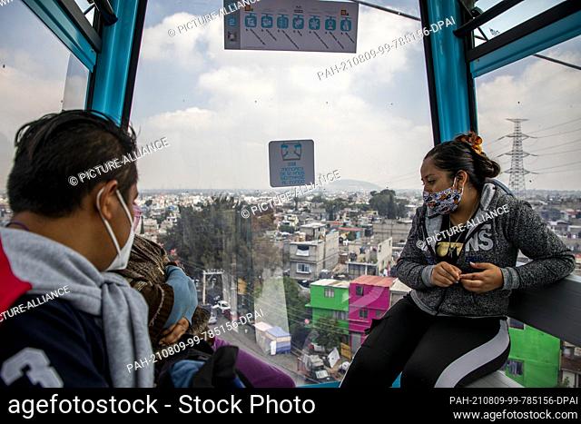 09 August 2021, Mexico, Iztapalapa: A family rides in a cabin of the new cable car ""Cablebus 2"" and should be able to get to work an hour faster.