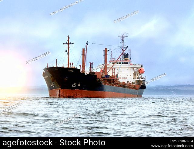 large cargo ship at sea background of blue sky in the calm