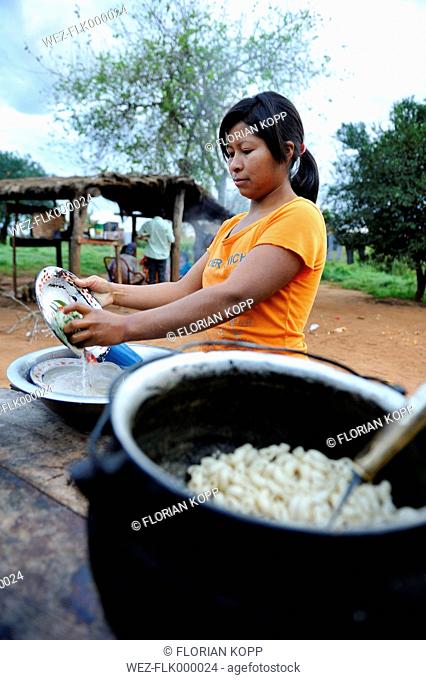 Paraguay, Caaguazu, Jaguary, Gurani woman cleaning dishes