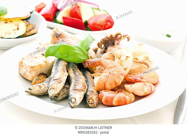 Seafood platter with vegetable and tzatziki as closeup