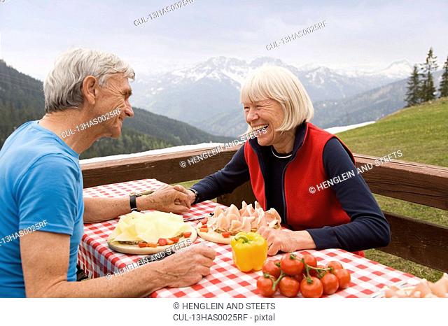 senior couple eating in mountains