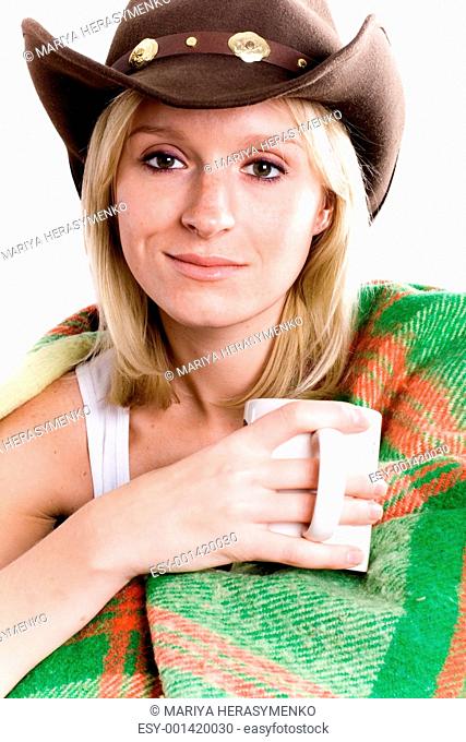 girl in a cowboy hat with cup of tea