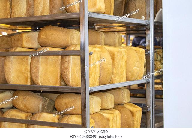 A lot of ready-made fresh bread in a mini bakery, Racks of hot bread, Bakery business, space for text