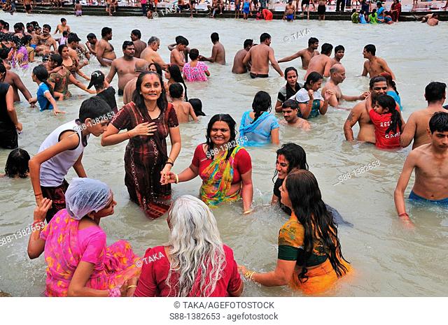 Pilgrims bathing at Har Ki Pairi ghat by the Ganges river