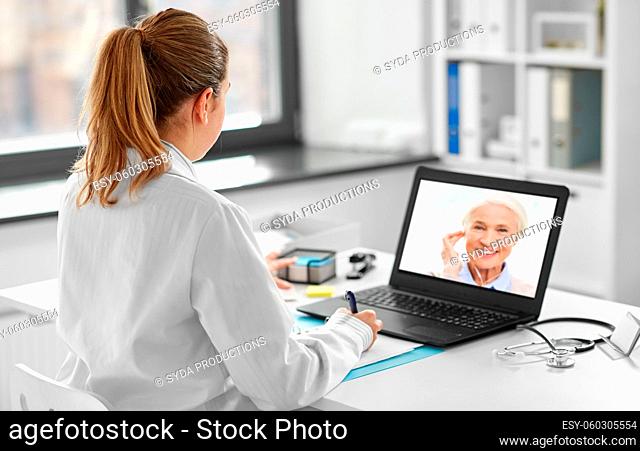 doctor with laptop having video call with patient