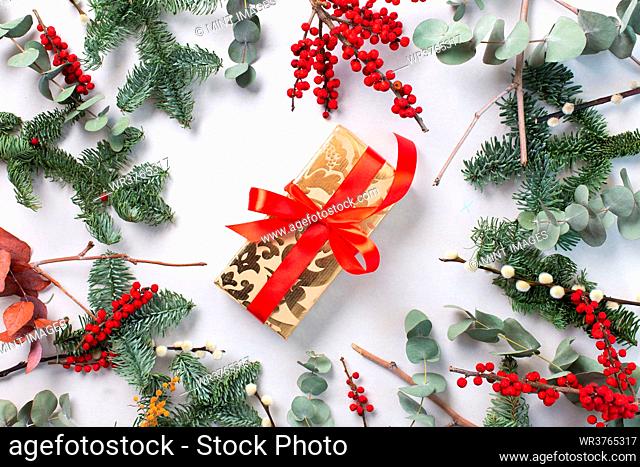 Christmas decorations on a white background, and a gift wrapped present