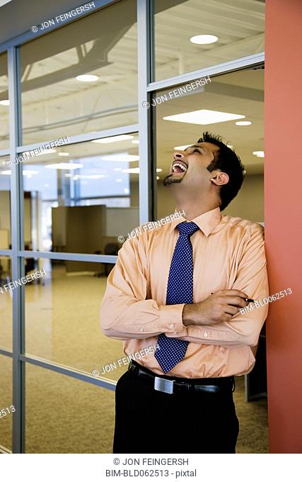 Indian businessman laughing in office