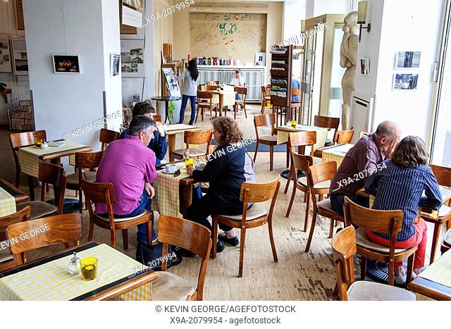 Interior of Cafe Sibylle, Karl Marx Allee Street, Berlin; Germany with Old Red Mercedes Car