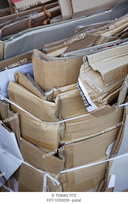 Flattened cardboard boxes tied with twine and ready to be recycled