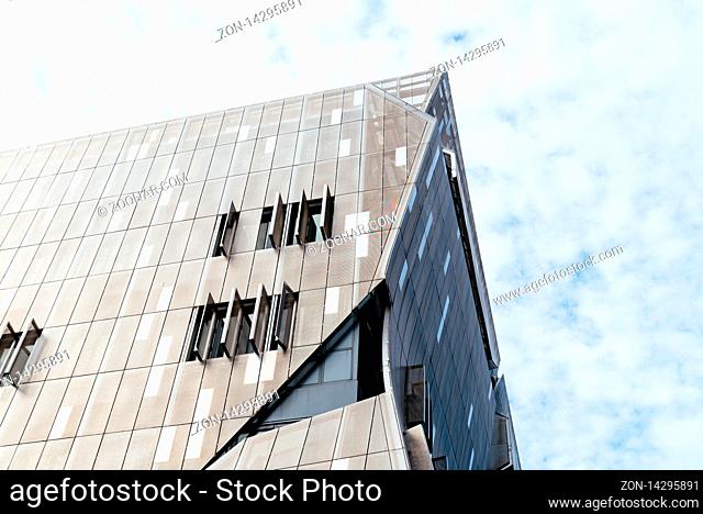New York City, USA - June 20, 2018: Low angle view of Cooper Square building in New York. It was designed by Thom Mayne. It is an academic center that houses...