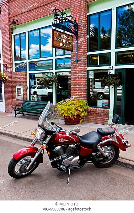 A MOTORCYCLE parked on the main street of CREEDE COLORADO, a silver mining town dating back to the mid 1800's which is now a tourist attraction and retirement...