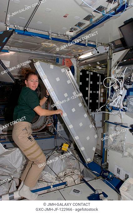 Astronaut Sandra Magnus, Expedition 18 flight engineer, works on a crew quarters compartment in the Harmony node of the International Space Station