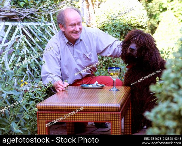Portrait of Graham Carr at garden table with dog