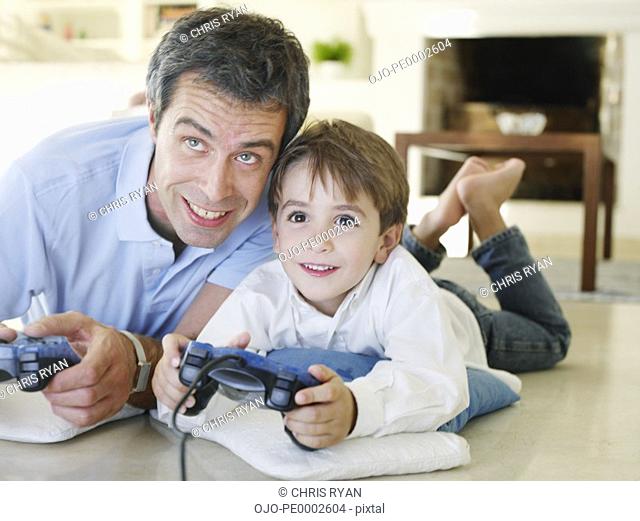 Father and son playing video game together