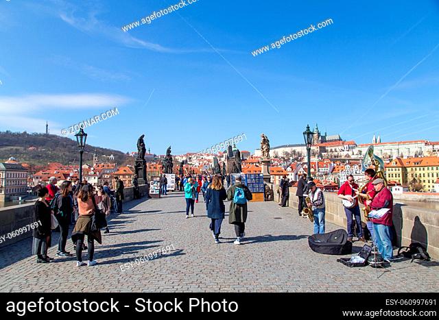 Prague, Czech Republic - March 16, 2017: People walking on the damous Charles Bridge in the city centre