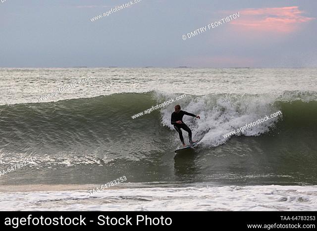 RUSSIA, SOCHI - NOVEMBER 13, 2023: A surfer rides a wave during a storm on the Black Sea, in the Khosta neighbourhood. Dmitry Feoktistov/TASS