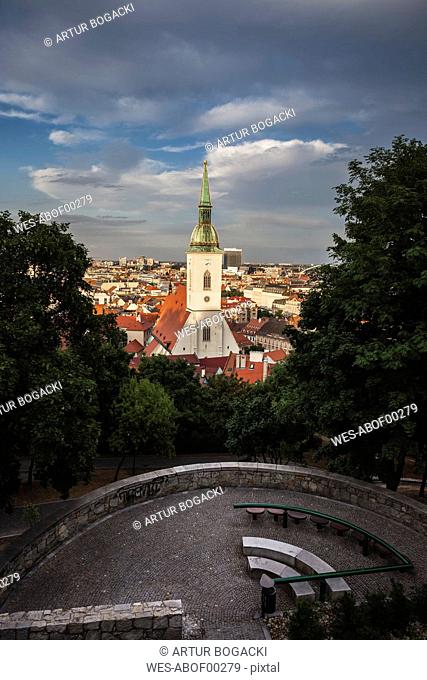 Slovakia, Bratislava, cityscape with St. Martin's Cathedral at sunset, hill park terrace with benches