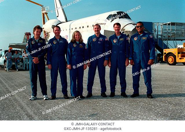 Following the landing of the Space Shuttle Discovery on runway 33 at the Kennedy Space Center (KSC), the six member crew poses for a final crew portrait