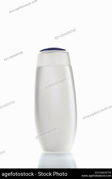white bottle with a blue lid for storing shampoo, shower gel and other liquid cosmetics. on a white isolated background