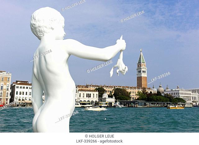 Boy with a frog sculpture by artist Charles Ray on the Punta della Dogana with Campanile tower in the background, Campanile di San Marco, Venice, Veneto, Italy