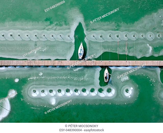 Boats frozen in the water on lake Balaton