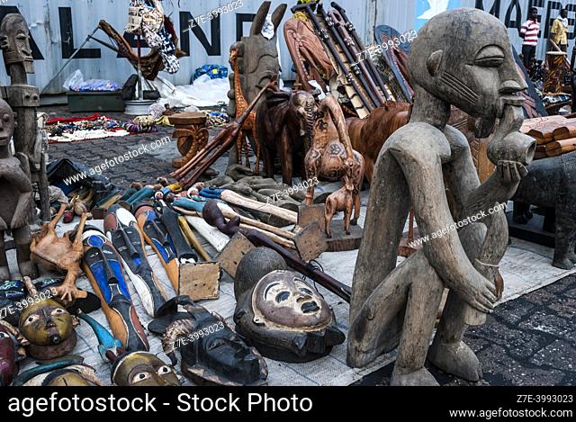 Shopping for traditional crafts: woodcarvings. Lomé, Togo, West Africa