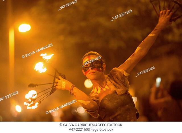 Woman dancing with fire in the streets of Gandia, Valencia, Spain