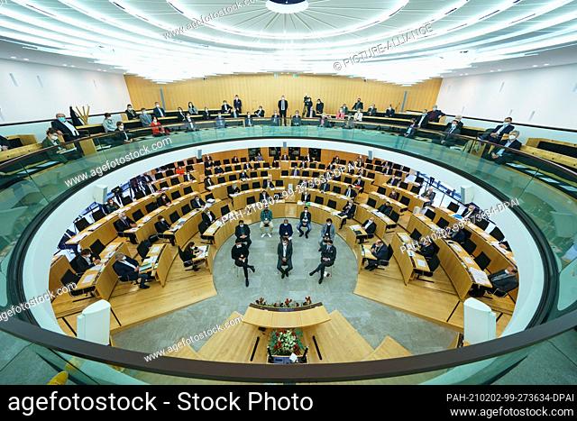 02 February 2021, Hessen, Wiesbaden: The relatives and survivors of the attack sit in the middle of the state parliament, the deputies in their seats