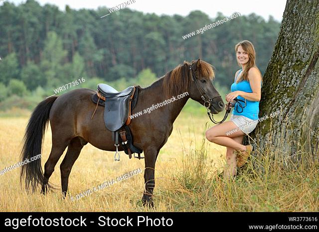 Young woman with an icelandic horse, Franconia, Bavaria, Germany, Europe