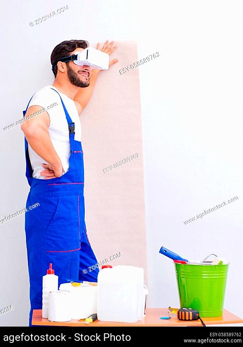 The man with vr glasses gluing wallpaper