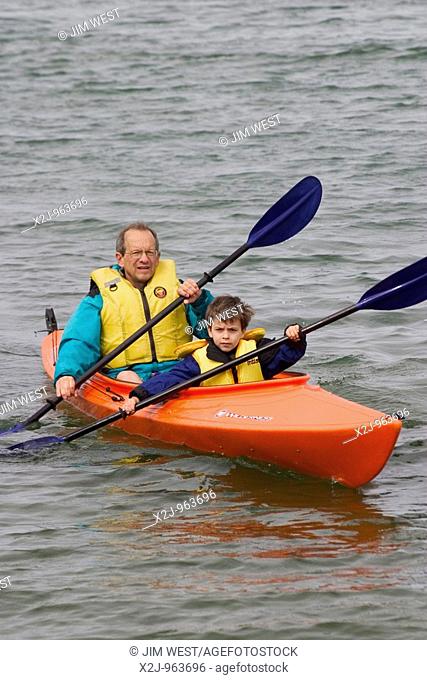 Tobermory, Ontario Canada - August 11, 2004 - John West and his son, Joey, 5, paddle a kayak in Hay Bay on Lake Huron  MR