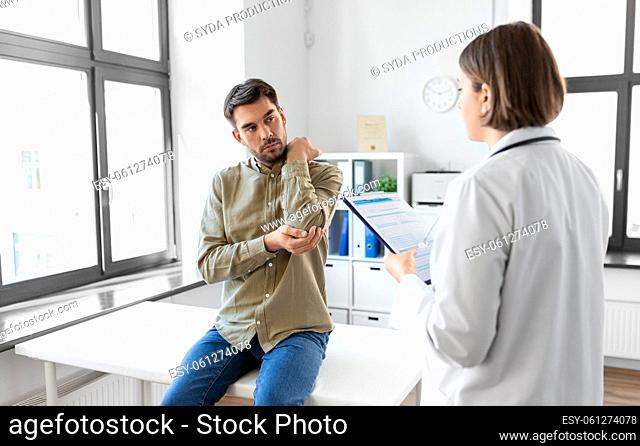 man patient showing sore arm to doctor at hospital