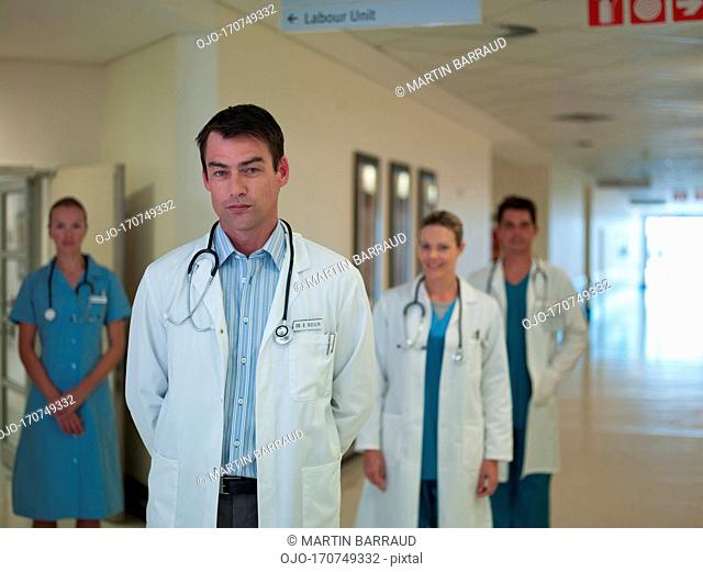 Doctors and nurse standing in hospital corridor