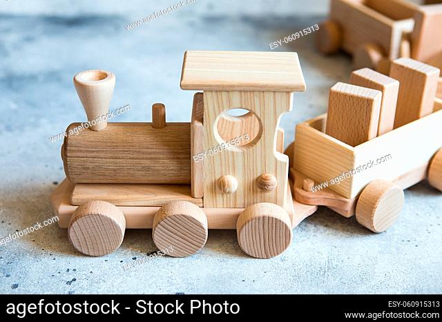 Children's wooden toys. Children wooden train with wagons. Natural wood construction set. Educational equipment. Children's wooden locomotive with various cargo...