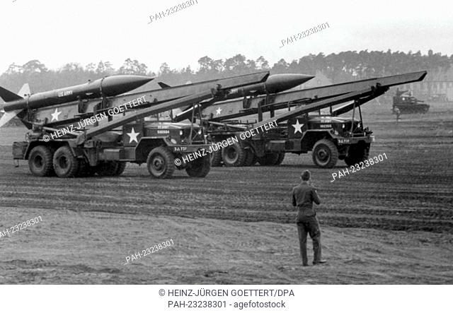 Vehicles with two 'Honest John' rockets of the 3rd US armed division driving over the parade ground in celebration of the 17th anniversary of their division on...