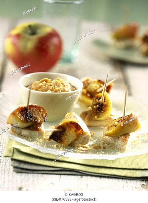 Stewed apples with peanuts and bite-size chicken brochettes